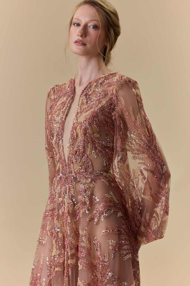 A fully embroidered tulle dress with puffed sleeves and a front slit.