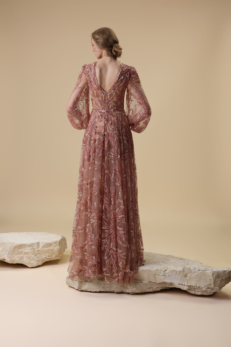 A fully embroidered tulle dress with puffed sleeves and a front slit.