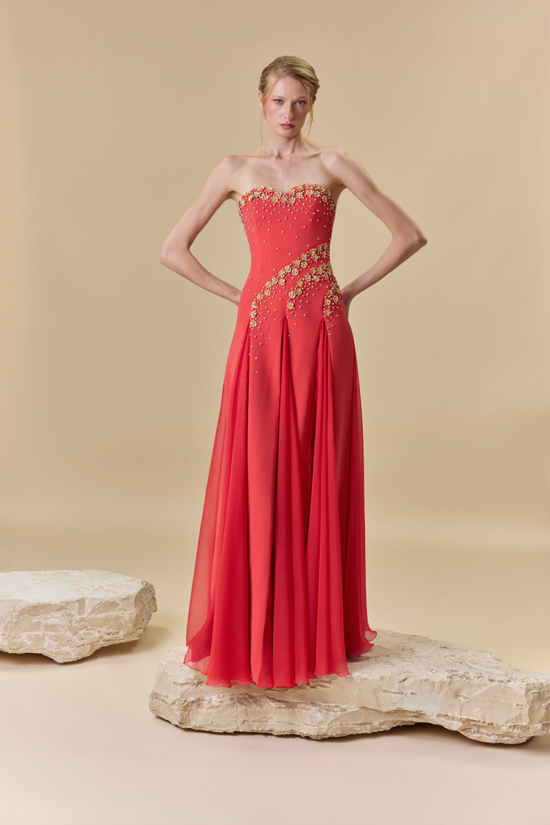 A strapless crêpe dress with A-line chiffon godet panels , embellished with metallic flowers and crystals.