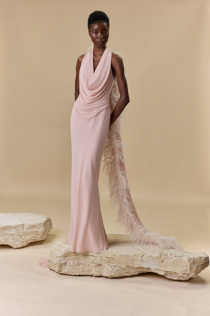 A georgette draped halter-neck dress a trimmed feather cape.