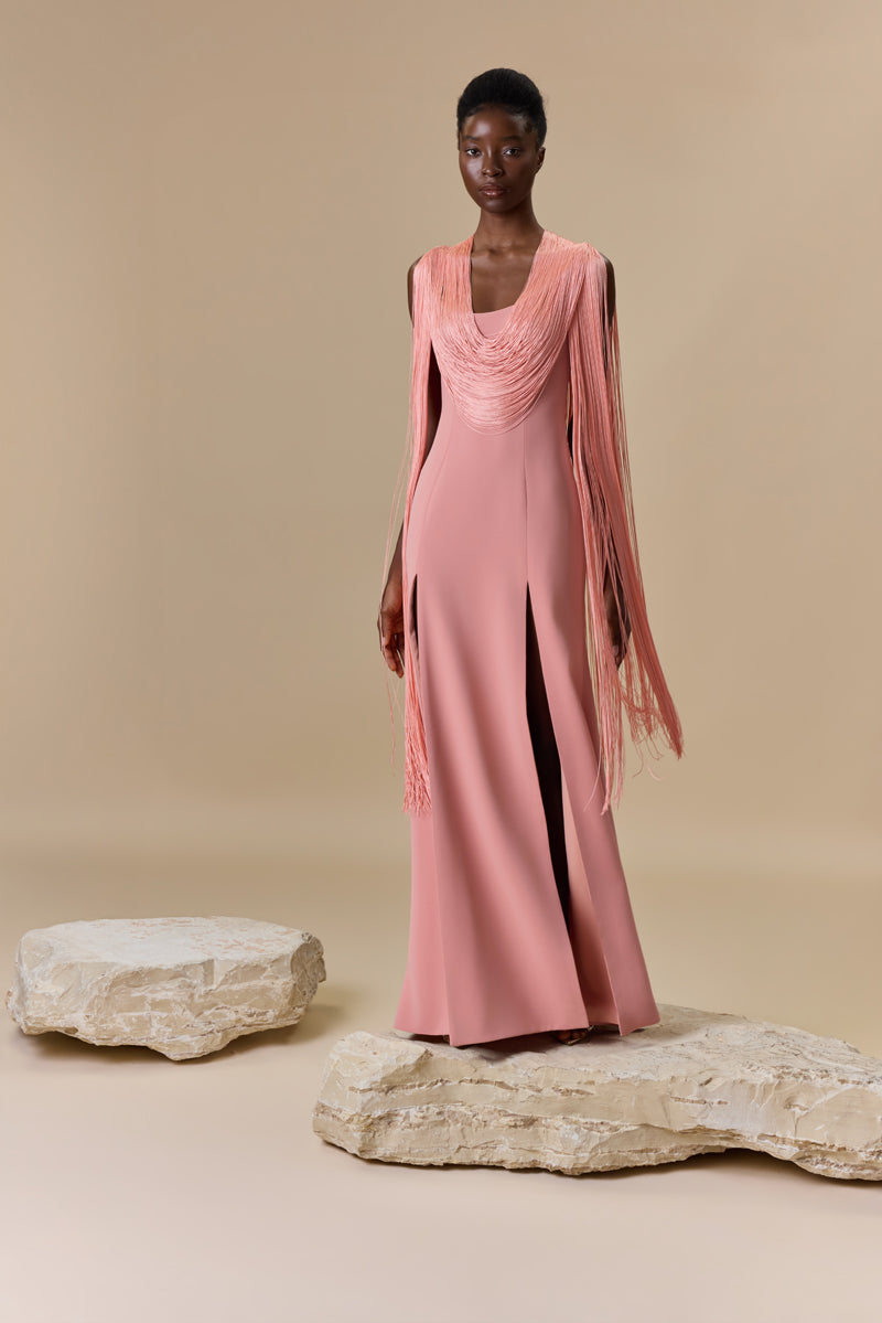 A crepe straight dress with silk fringes on sleeves and neckline with a high front slit.
