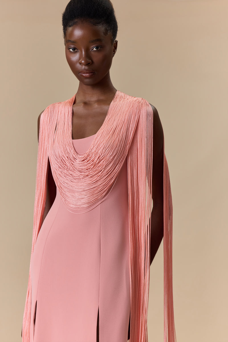 A crepe straight dress with silk fringes on sleeves and neckline with a high front slit.