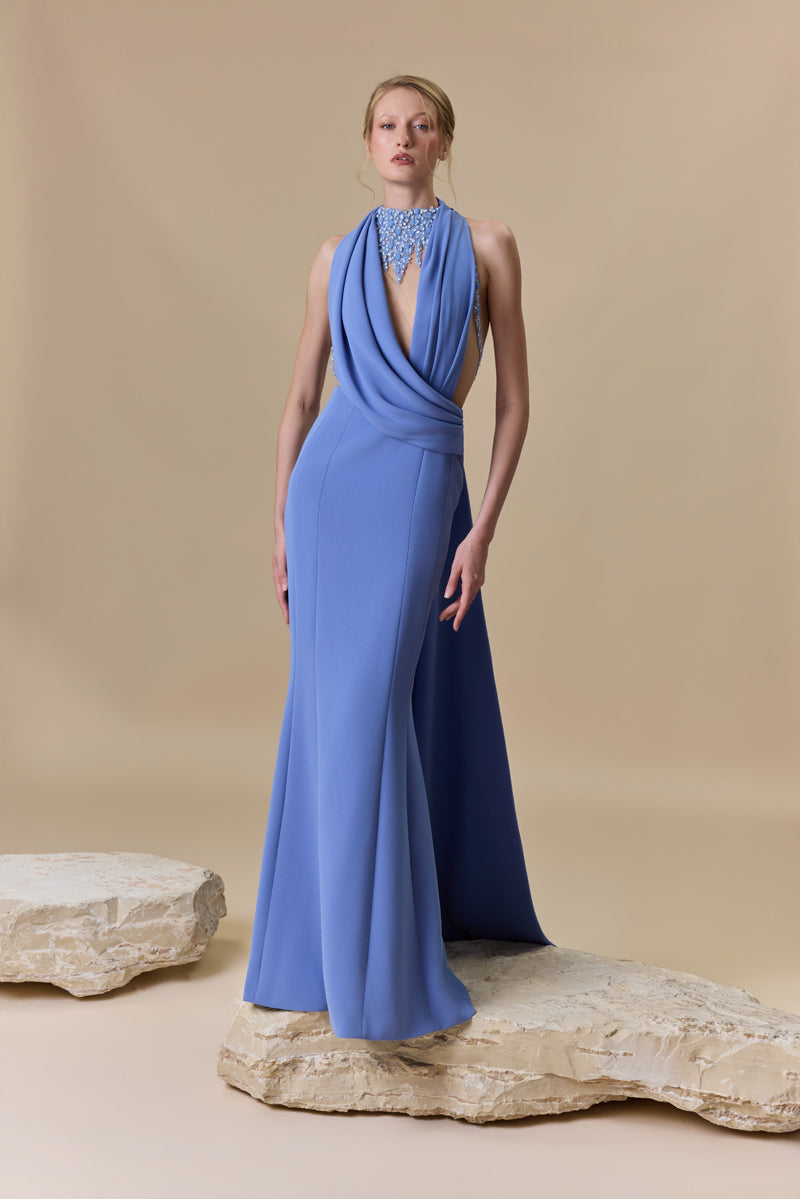 A fitted straight crêpe dress embellished with shimmering accents of crystals and beadings, designed with a plunging neckline and an open back.