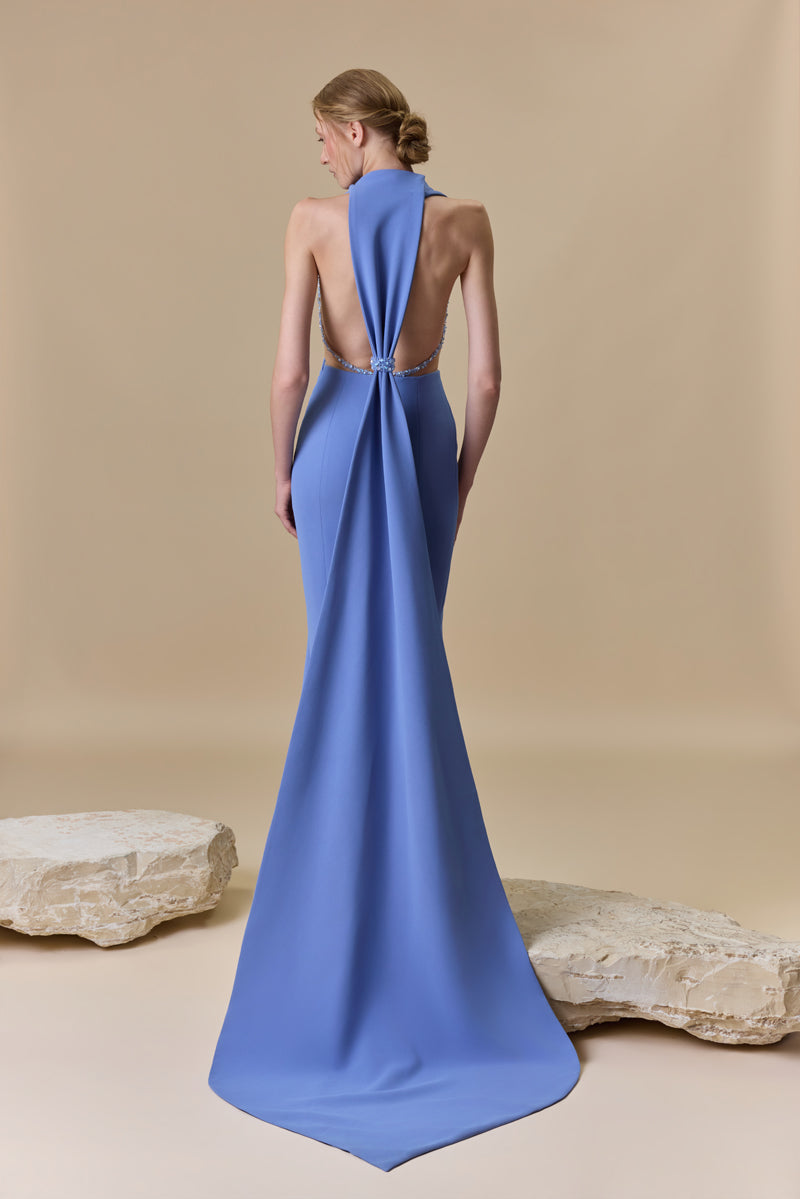 A fitted straight crêpe dress embellished with shimmering accents of crystals and beadings, designed with a plunging neckline and an open back.