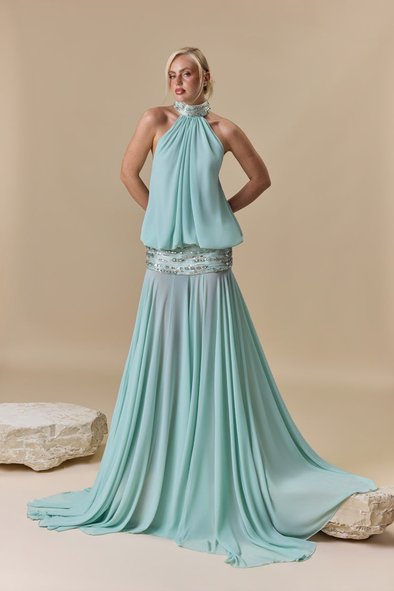 A georgette dress featuring a high neckline, a blouson effect halter bodice, and a flowing A-line skirt, with crystal embellishment along the neckline and waist.