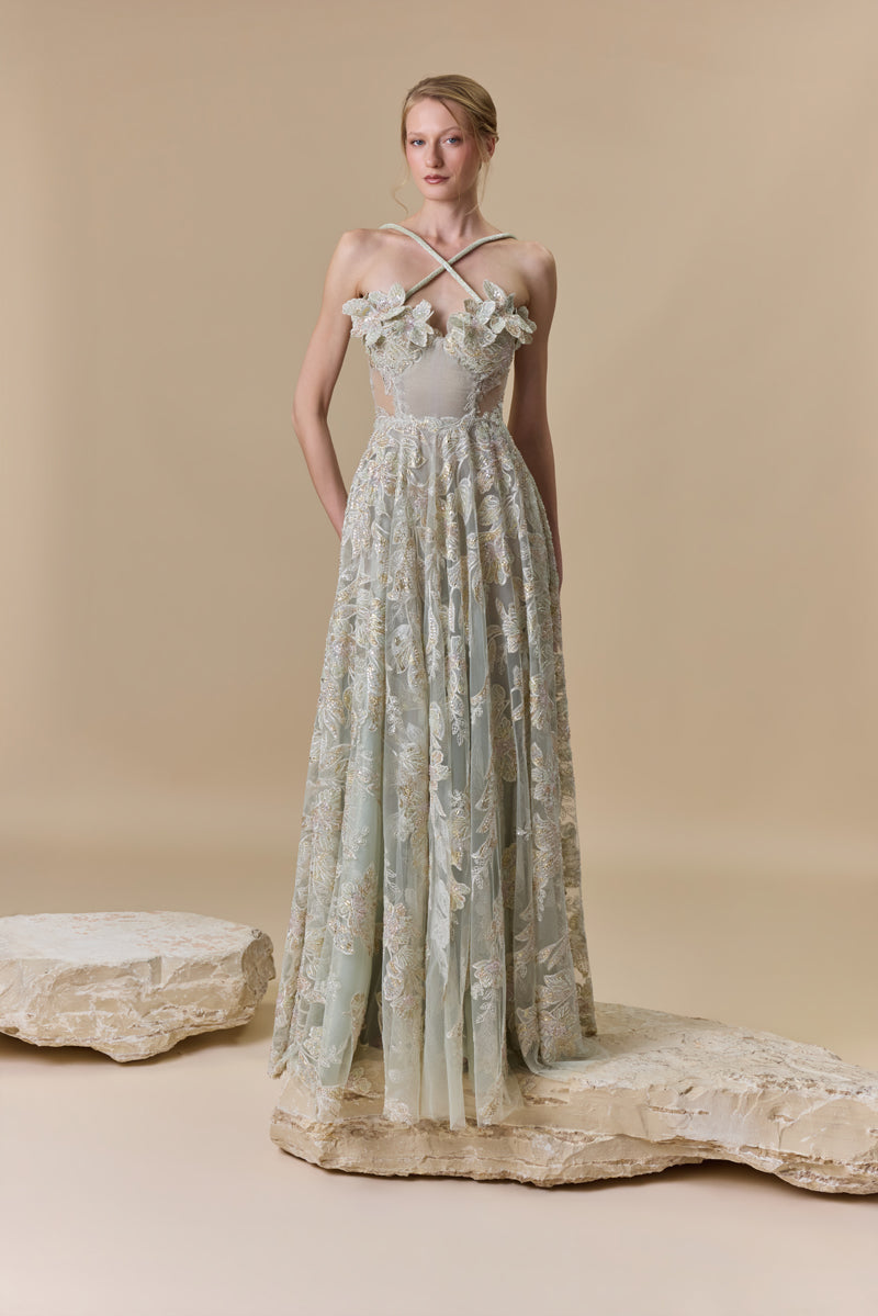 An embroidered tulle A-line dress with 3D flowers on the bust and halter beaded cords on the neck.