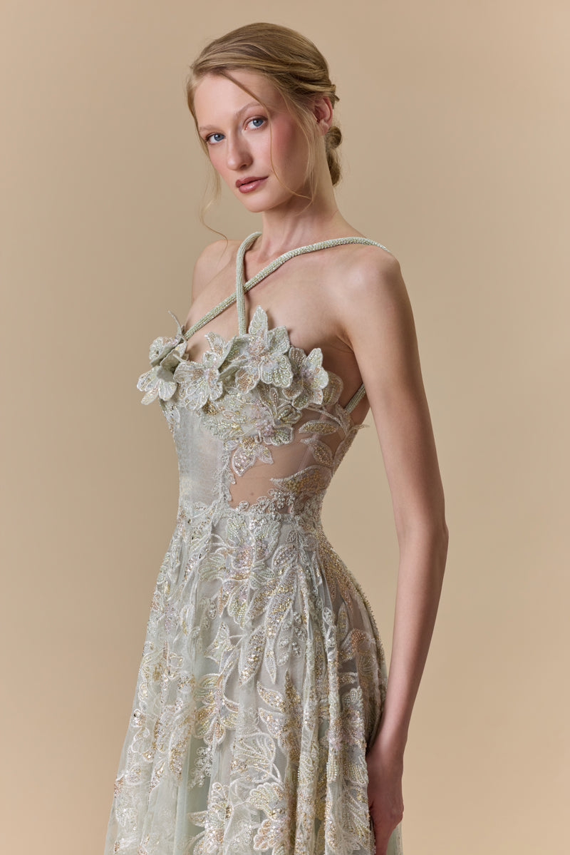 An embroidered tulle A-line dress with 3D flowers on the bust and halter beaded cords on the neck.