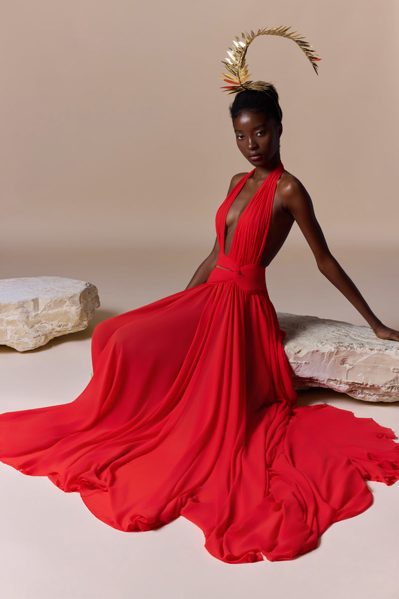 A flowing deep V georgette dress with a knot detail at the waist and a high slit.