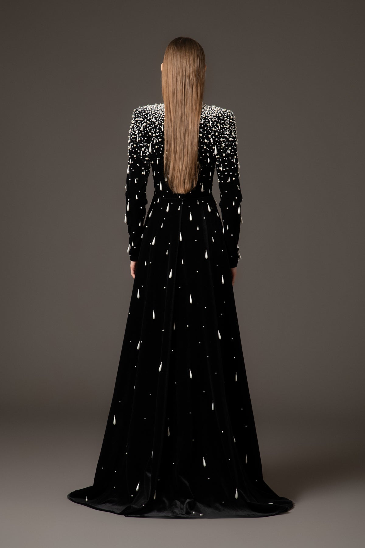 Black velvet dress with crystal and pearl embroidery paired with an overskirt