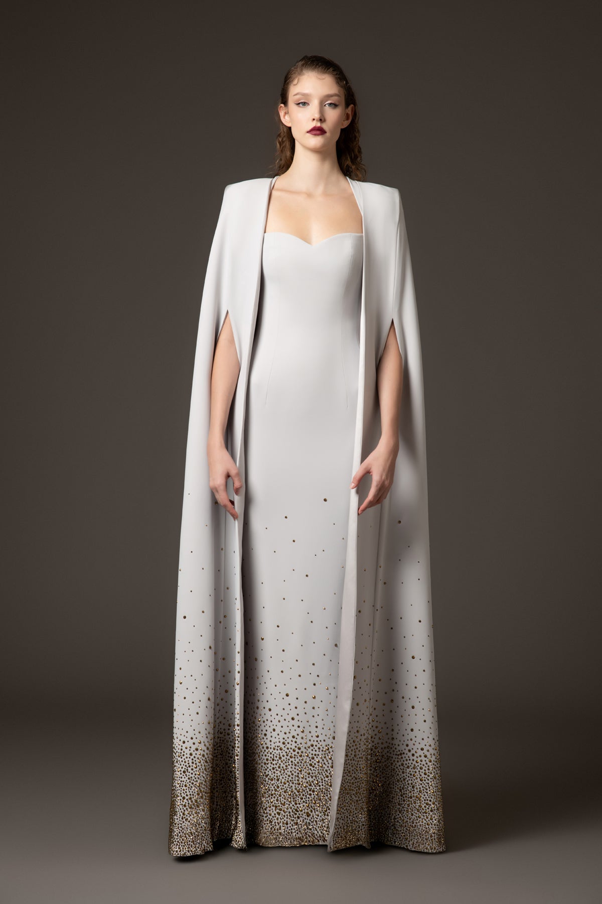 Embroidered light grey crpe dress paired with a cape Embroidered light grey crpe dress paired with a cape