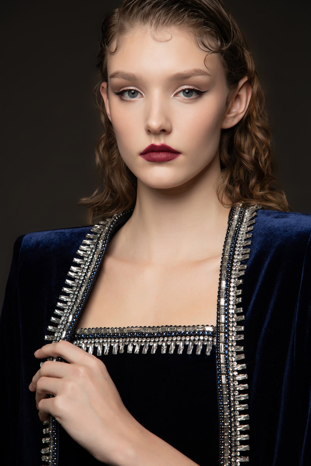 Embroidered velvet blue dress paired with a cape