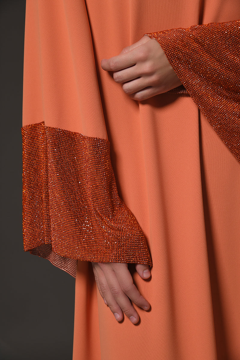 Orange crêpe abaya with crystal embellished chainmail along the neckline and sleeves