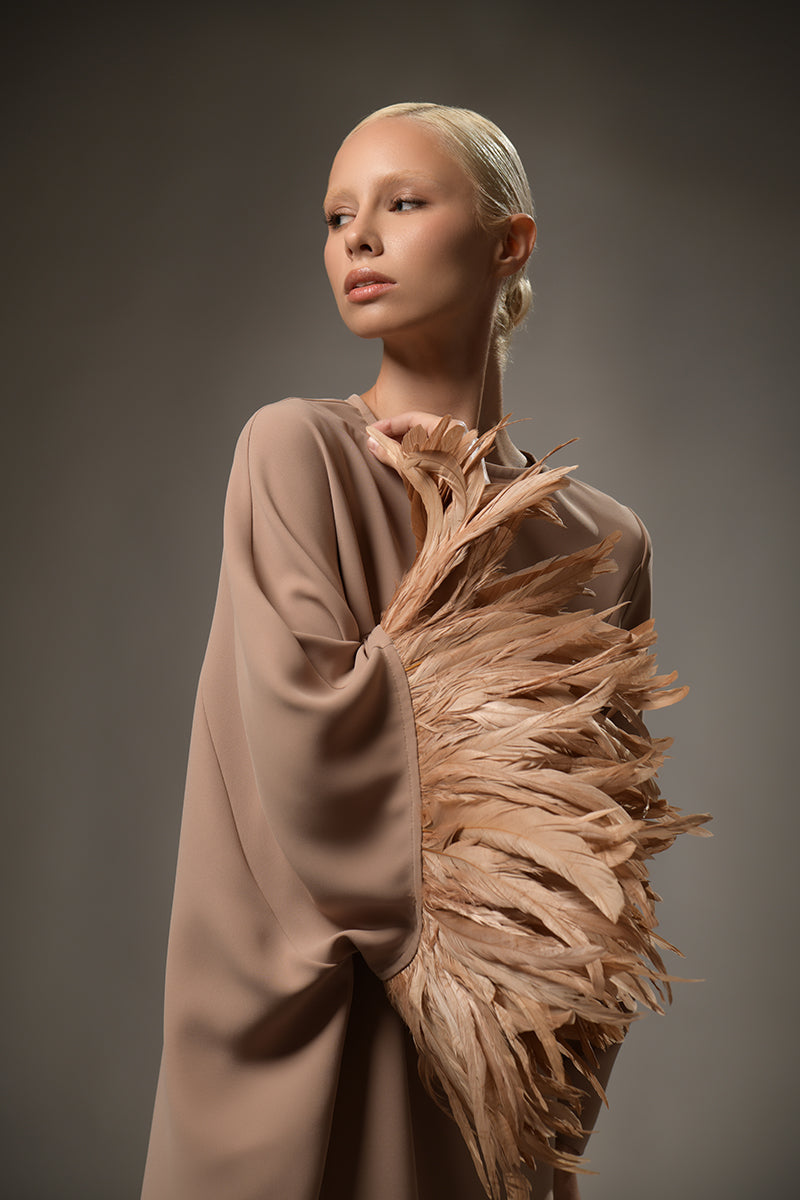 Brown abaya with feathers on the right hand sleeve