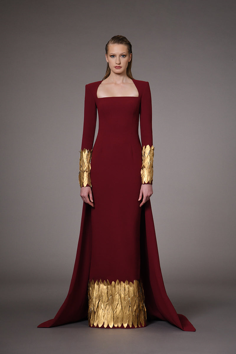 Burgundy dress with gold feathers on hem and sleeves
