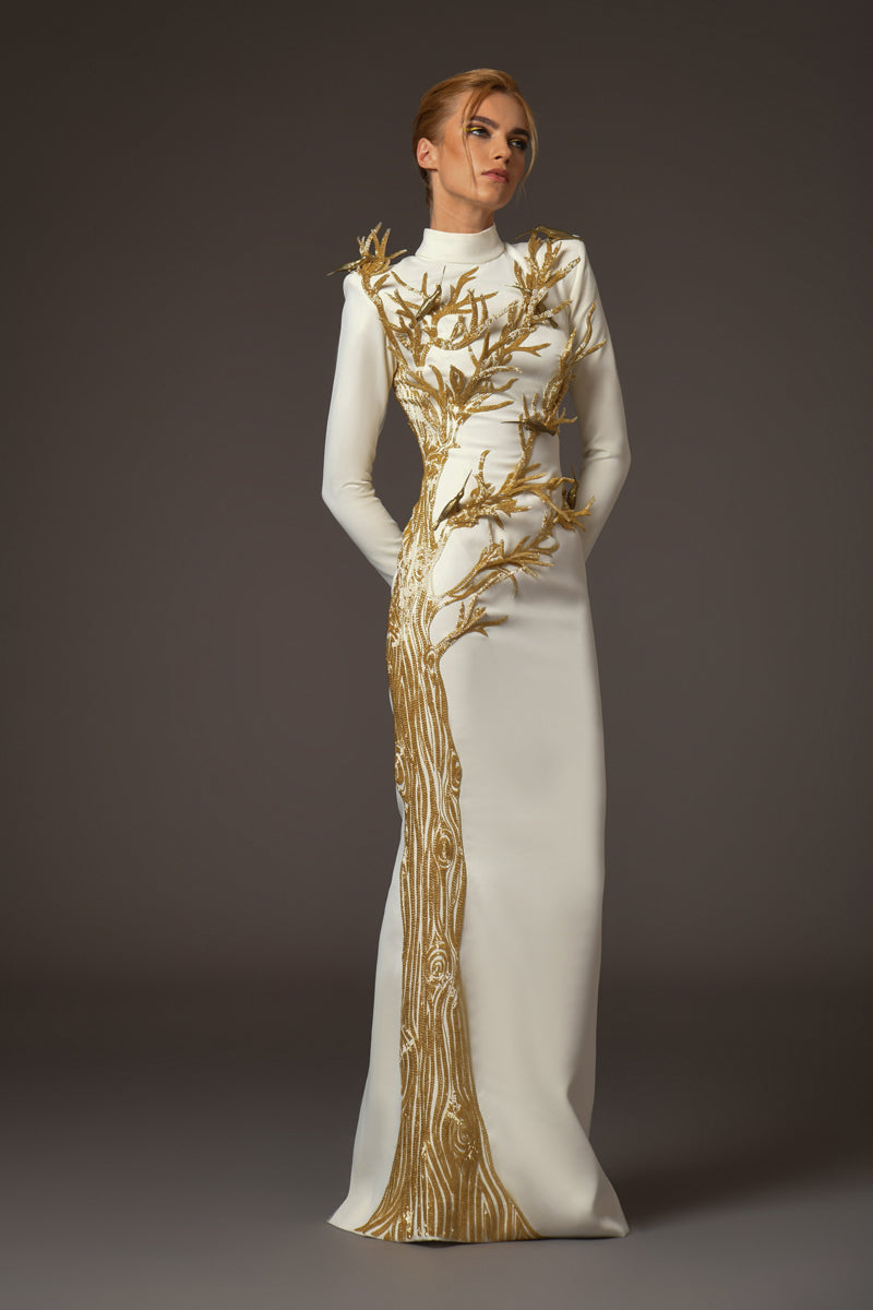 white crepe dress with golden tree and branches coming out of it and brass birds