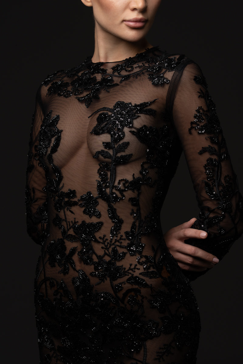 Sheer gown adorned with black embroidery, styled with a matching embroidered jacket