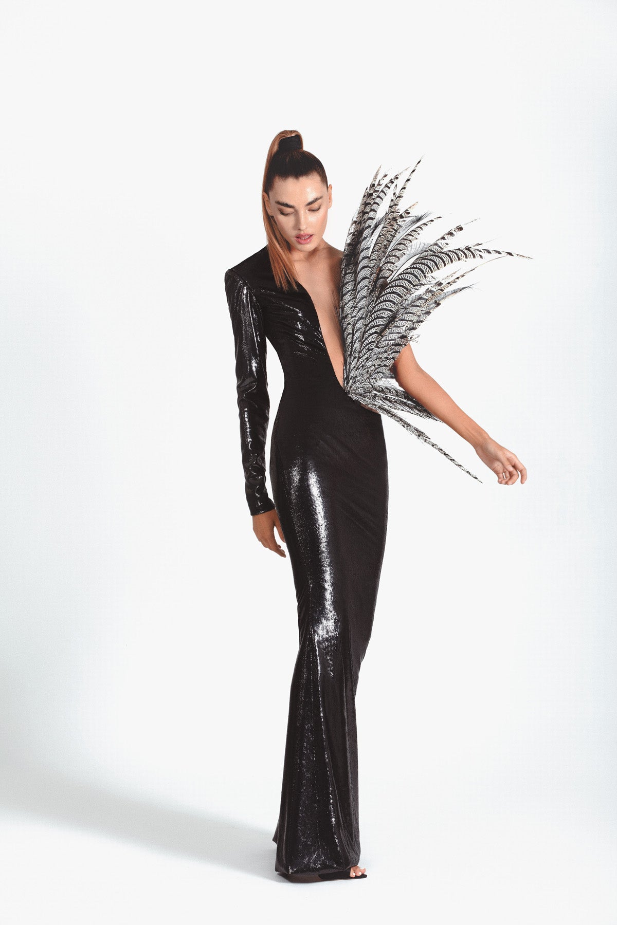 Slinky black dress in liquid velvet erupting with lady Amherst plumes
