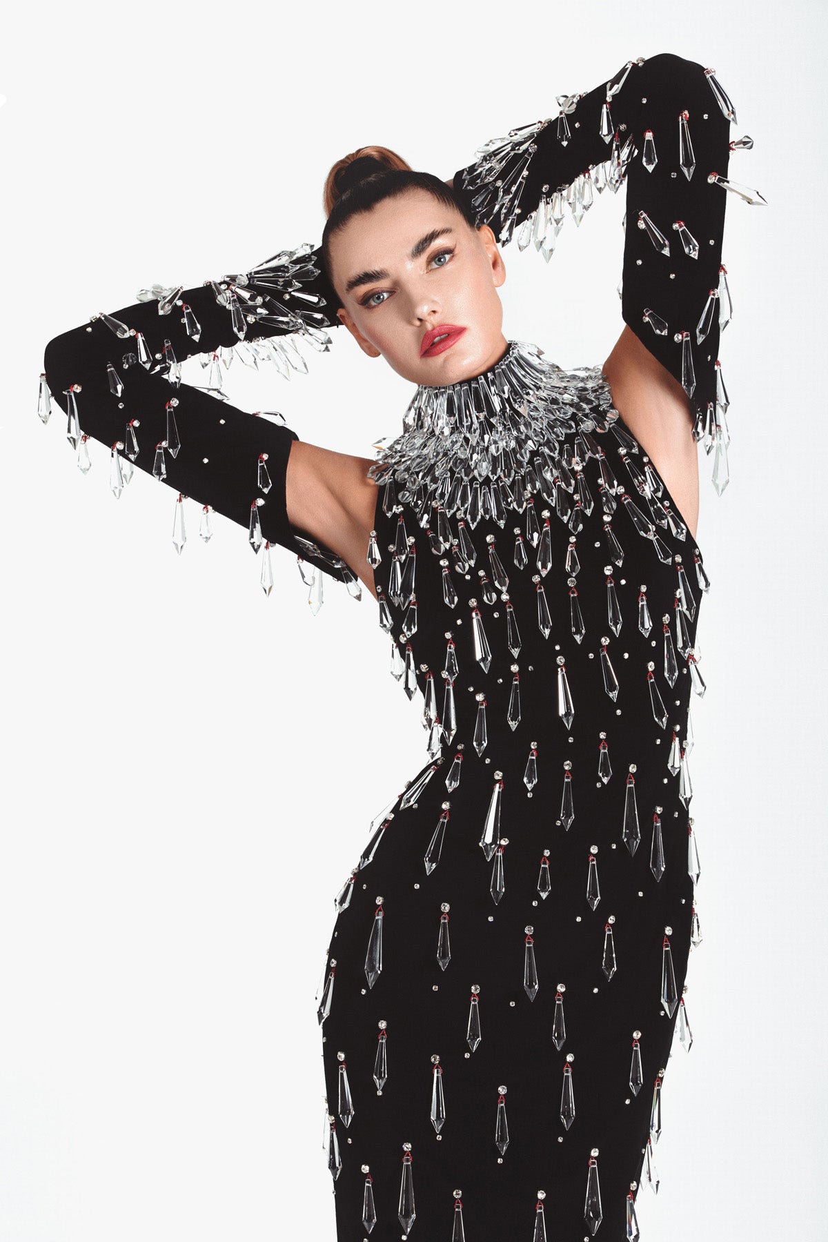 'The Frost', A Black velvet halter-neck dress embroidered with Swarovski stones and hanging chandelier crystal spikes worn with structured embroidered sleeves