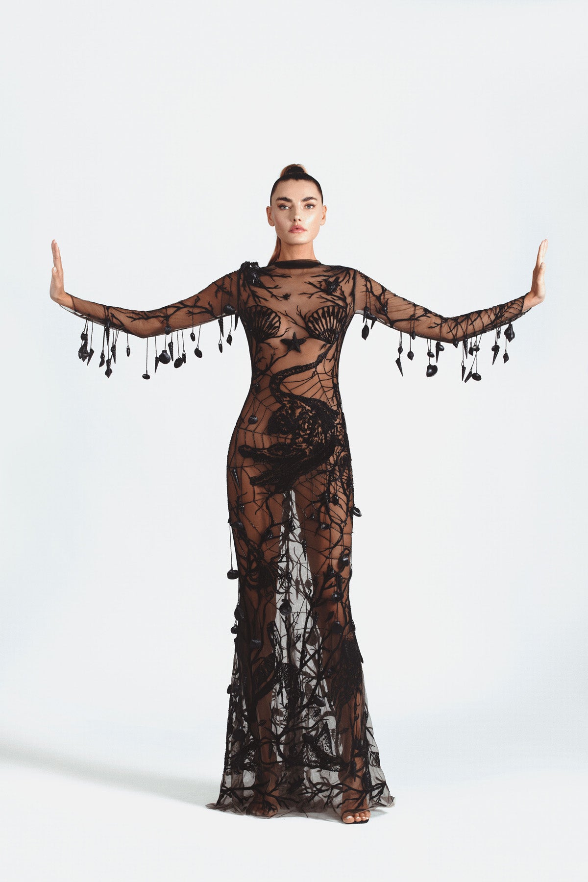 Black tulle embroidery of a seascape of sea creatures and underwater plant life