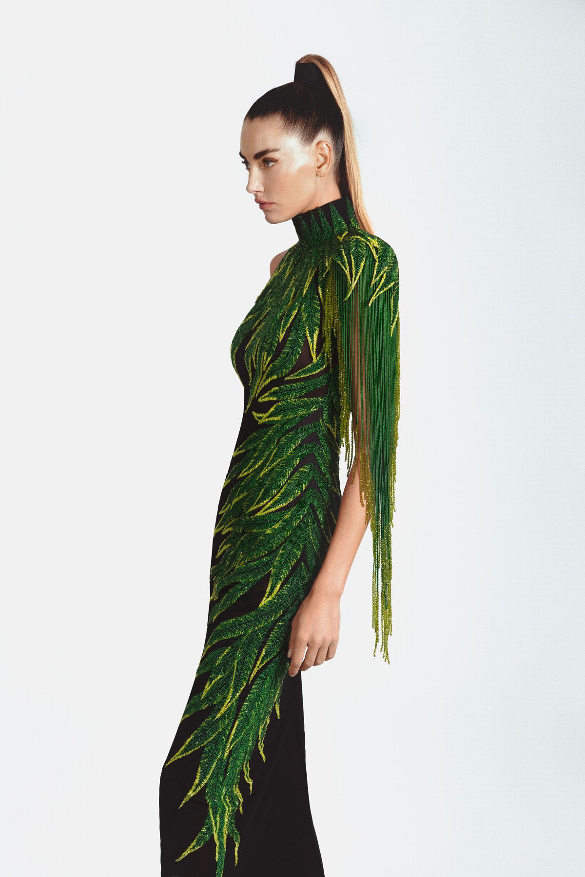High neck graphic dress in black silk jersey featuring embroidered leaves in glass beads, bugle beads, crystals and hanging beaded fringes