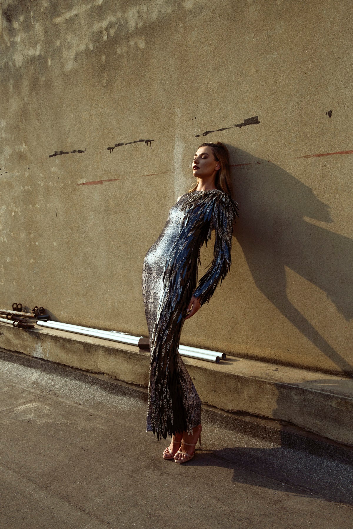 Round neck snakeskin dress covered in sparkly sequins and embellished with hand-painted plumes metamorphosing into a bird