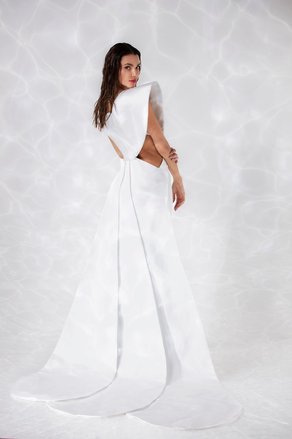 Sleeveless silky crêpe dress with a scallop shell inspired bustier and a layered overskirt in pearl white scuba