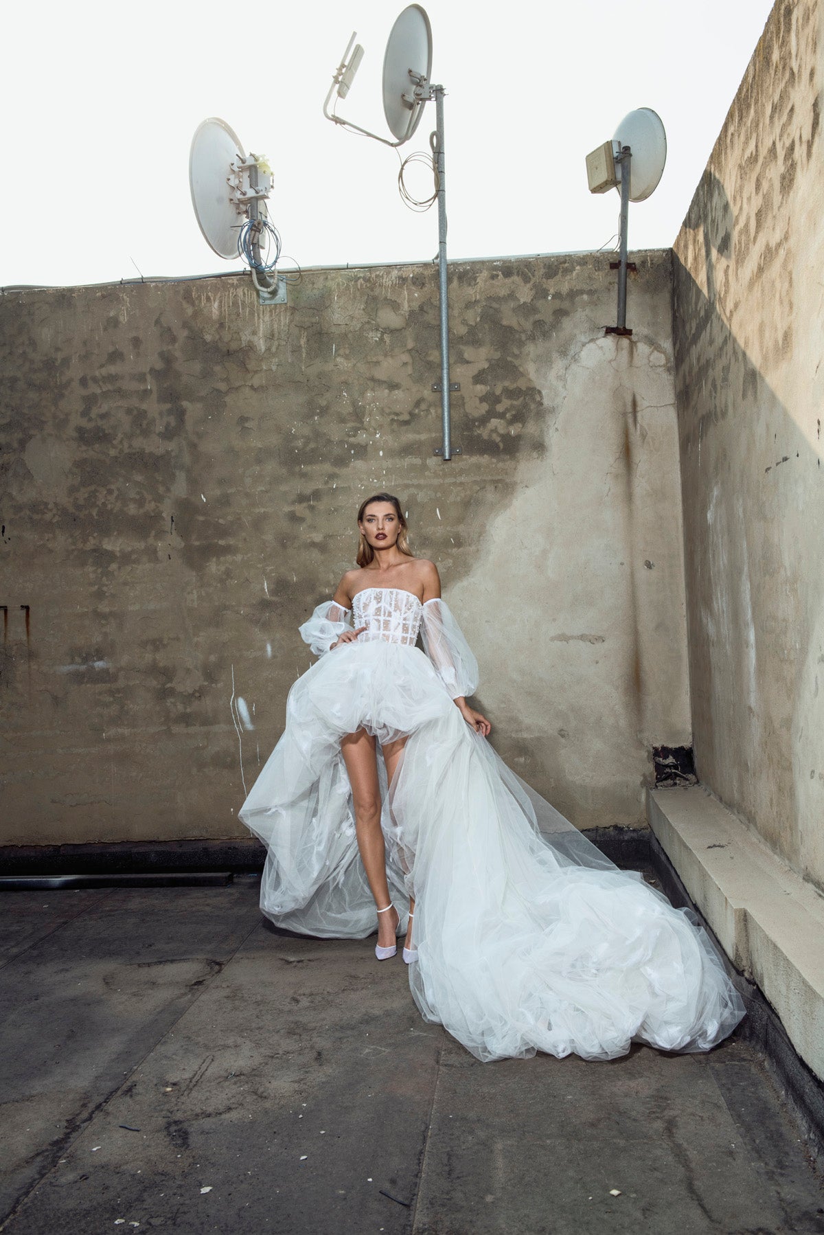 Chalk white corseted bustier puffball gown embellished with Swarovski crystals, pearls and trapped feathers