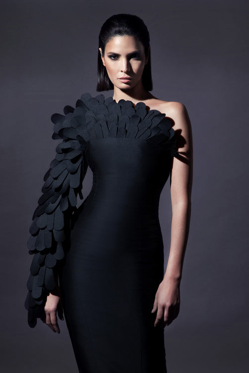 Black zibeline gown with a cluster of laser-cut plumes