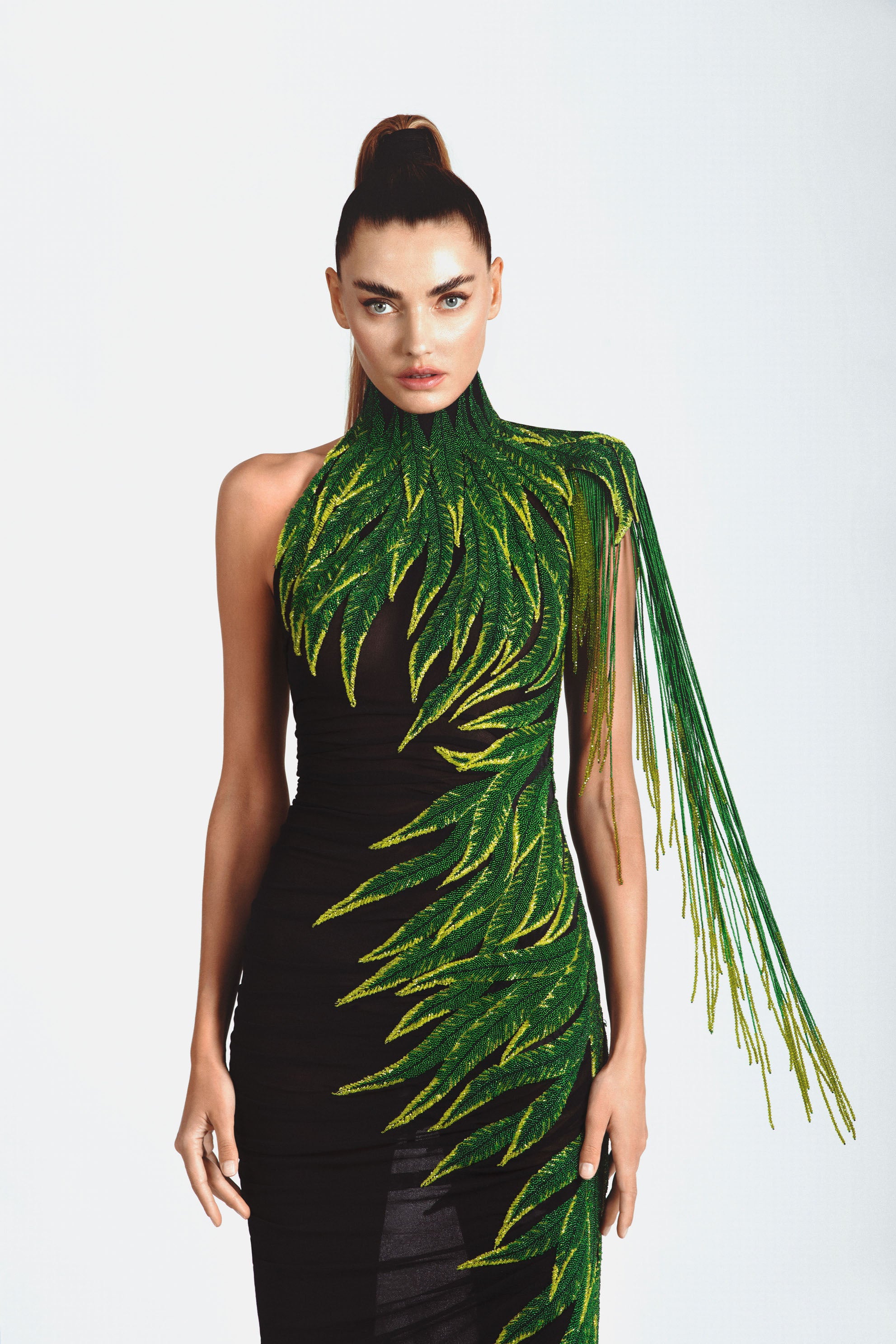 Sleeveless graphic dress in black silk jersey featuring embroidered leaves in glass beads, bugle beads, crystals and hanging beaded fringes