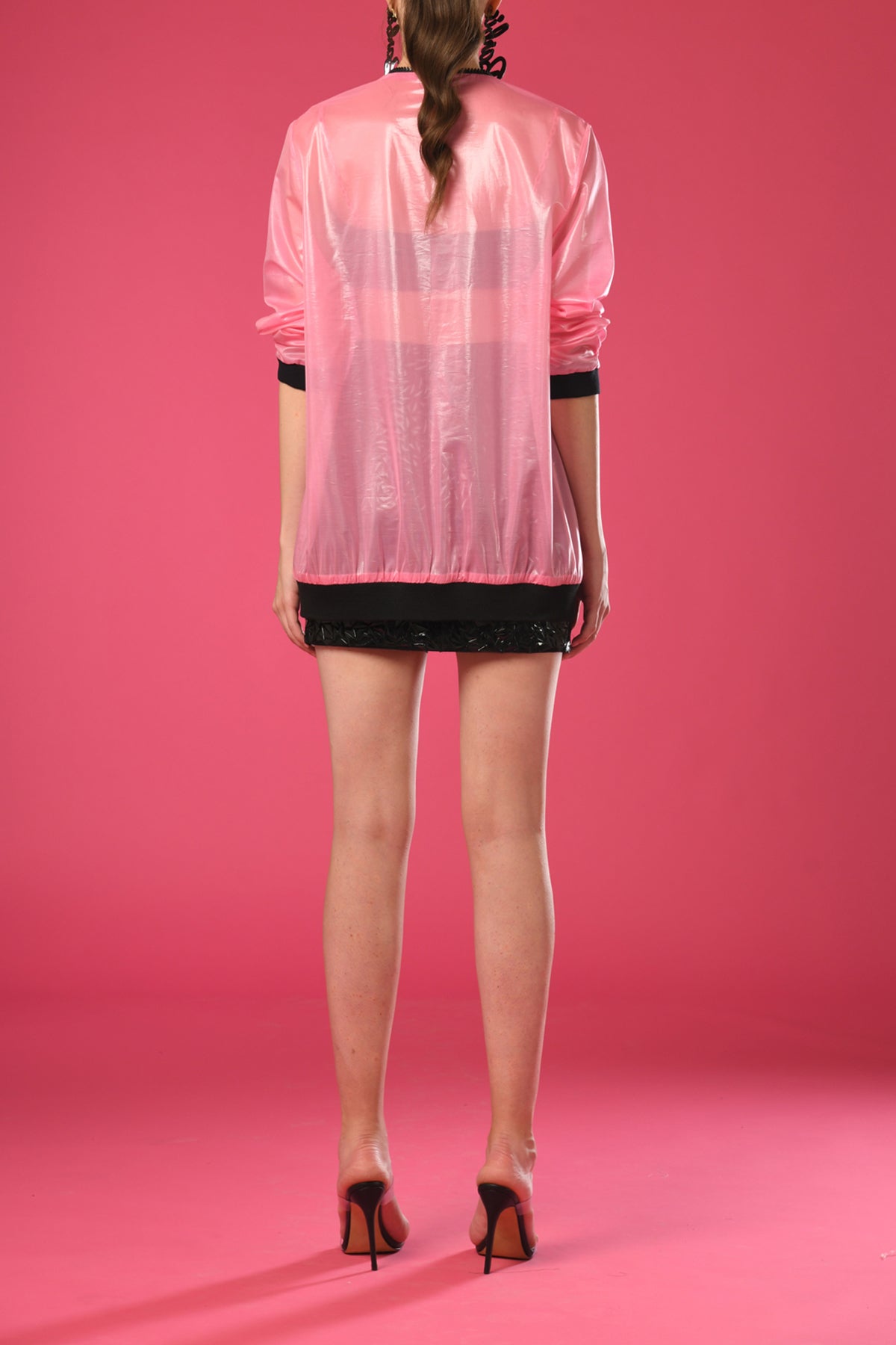 Black embroidered cropped top and skirt with sheer pink jacket
