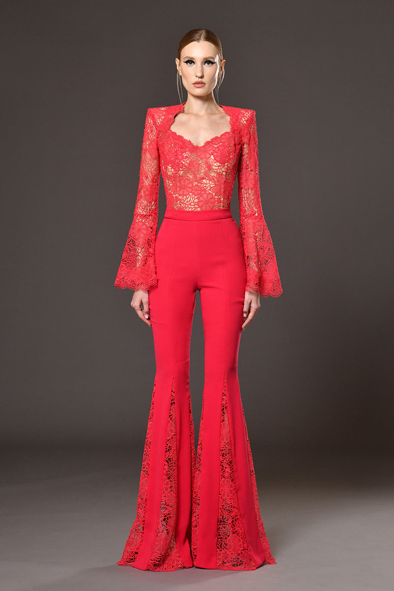 Red guipure top with structures shoulders and flared sleeves with red crêpe and guipure cutouts flared pants