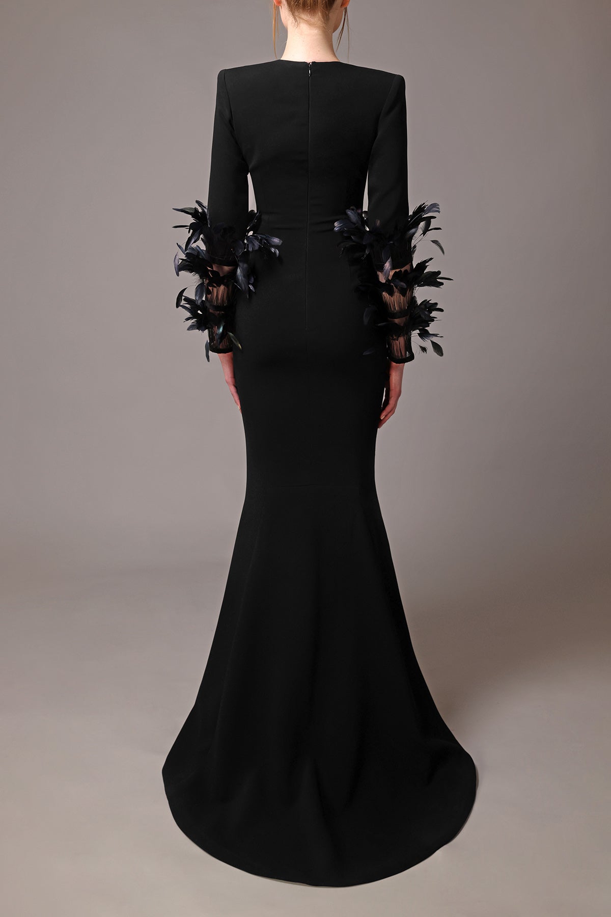 Mermaid cut black crêpe dress with feathered long sleeves