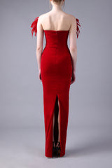 Deep red strapless fitted velvet dress with feathers