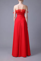 Red crêpe strapless dress with feathers on the bust