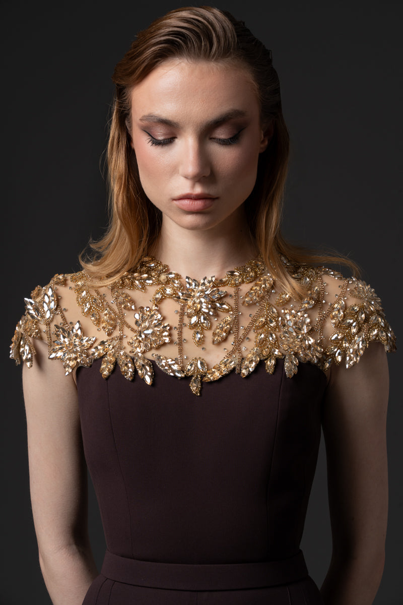 A crêpe jumpsuit with beaded neckline  and a  crêpe overskirt