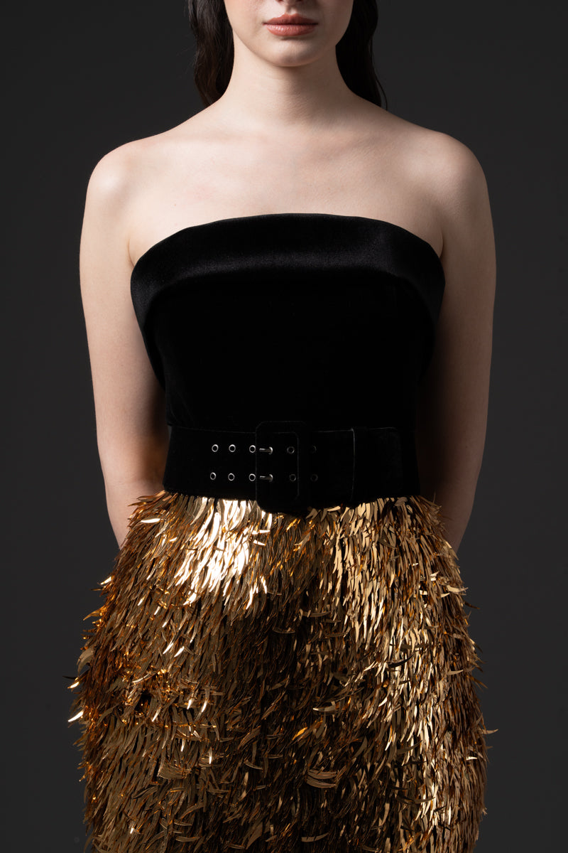 A fitted gold spikes embroidered skirt with velvet strapless corset and velvet belt.