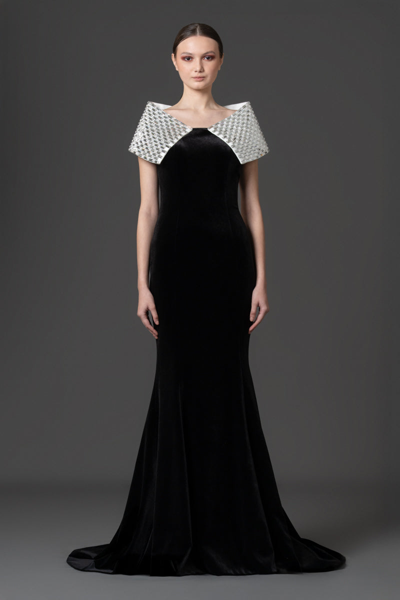 A sculptural velvet gown featuring a baguette-stone encrusted collar that  adds contrast to the look.