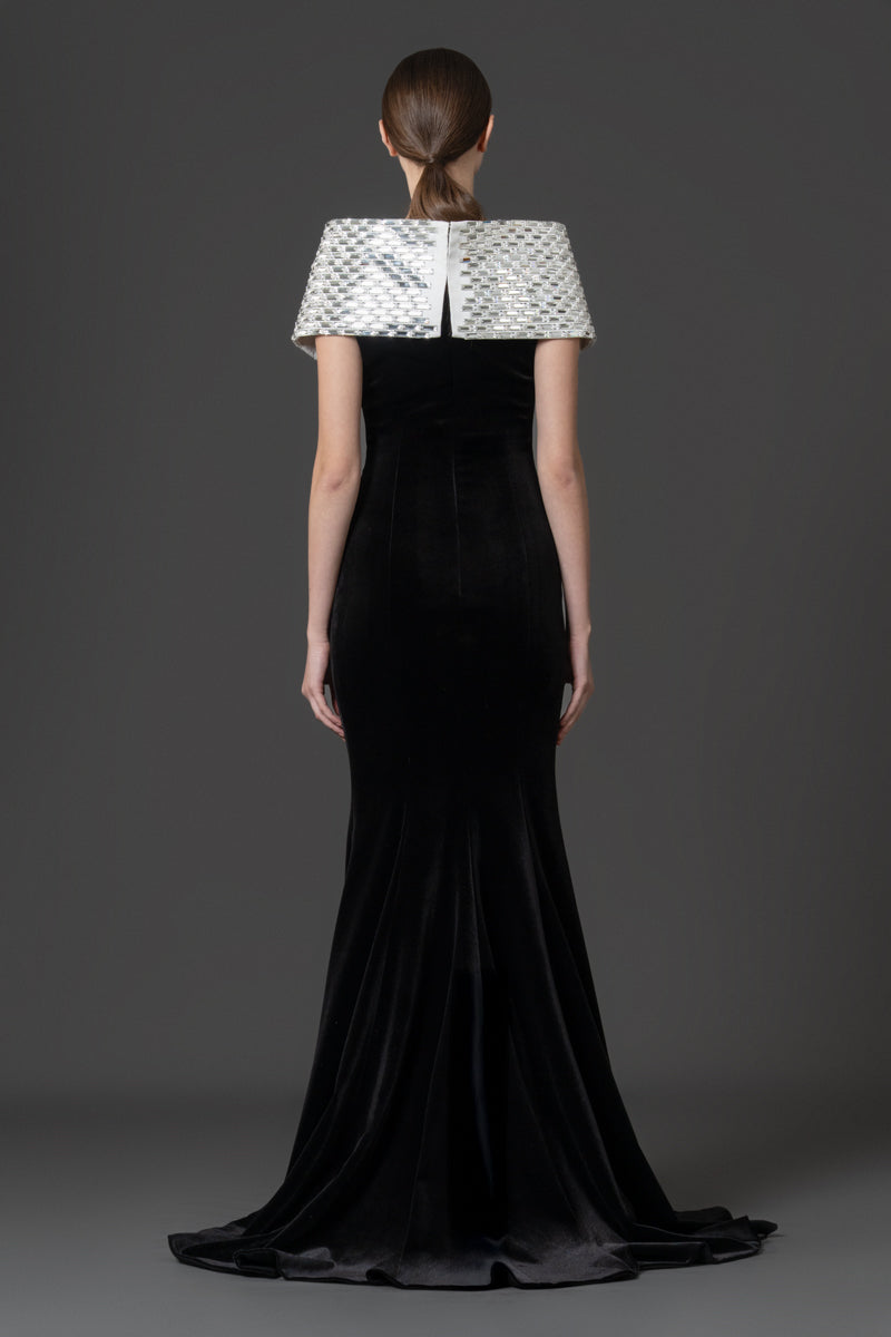 A sculptural velvet gown featuring a baguette-stone encrusted collar that  adds contrast to the look.