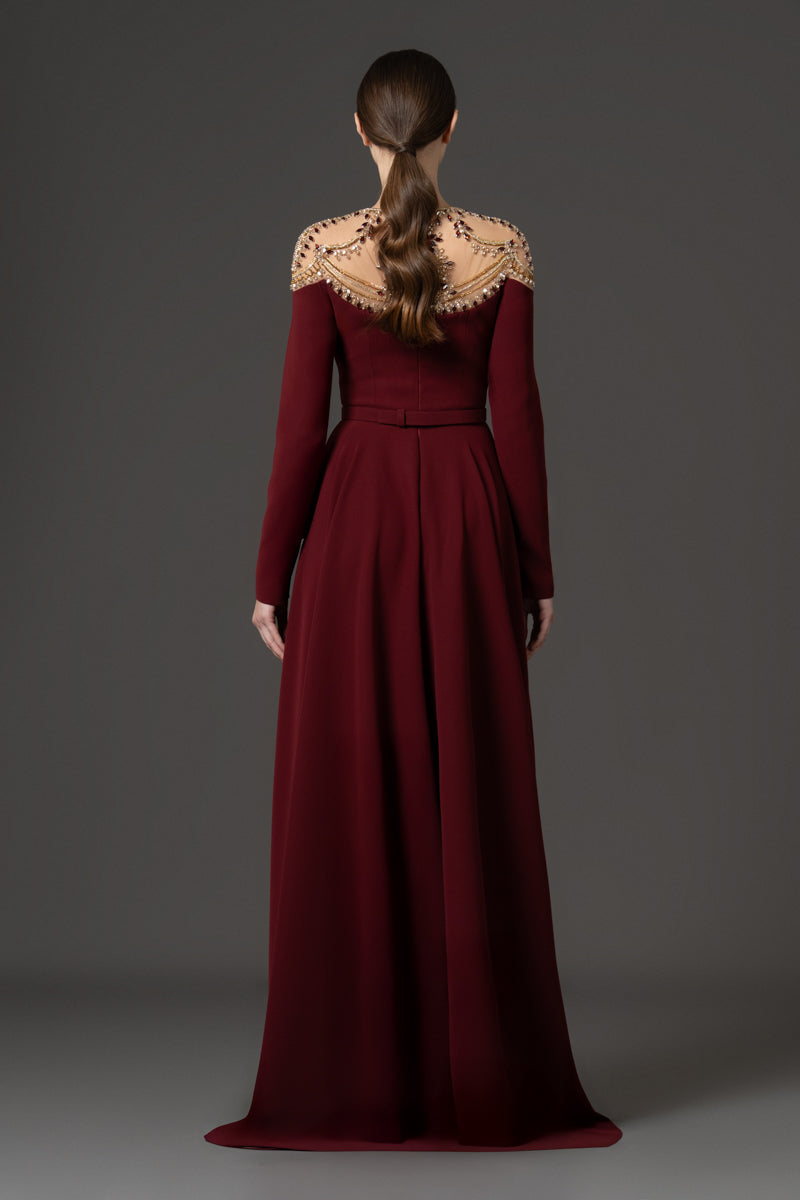 A-line gown featuring a sheer illusion neckline embellished with crystals.