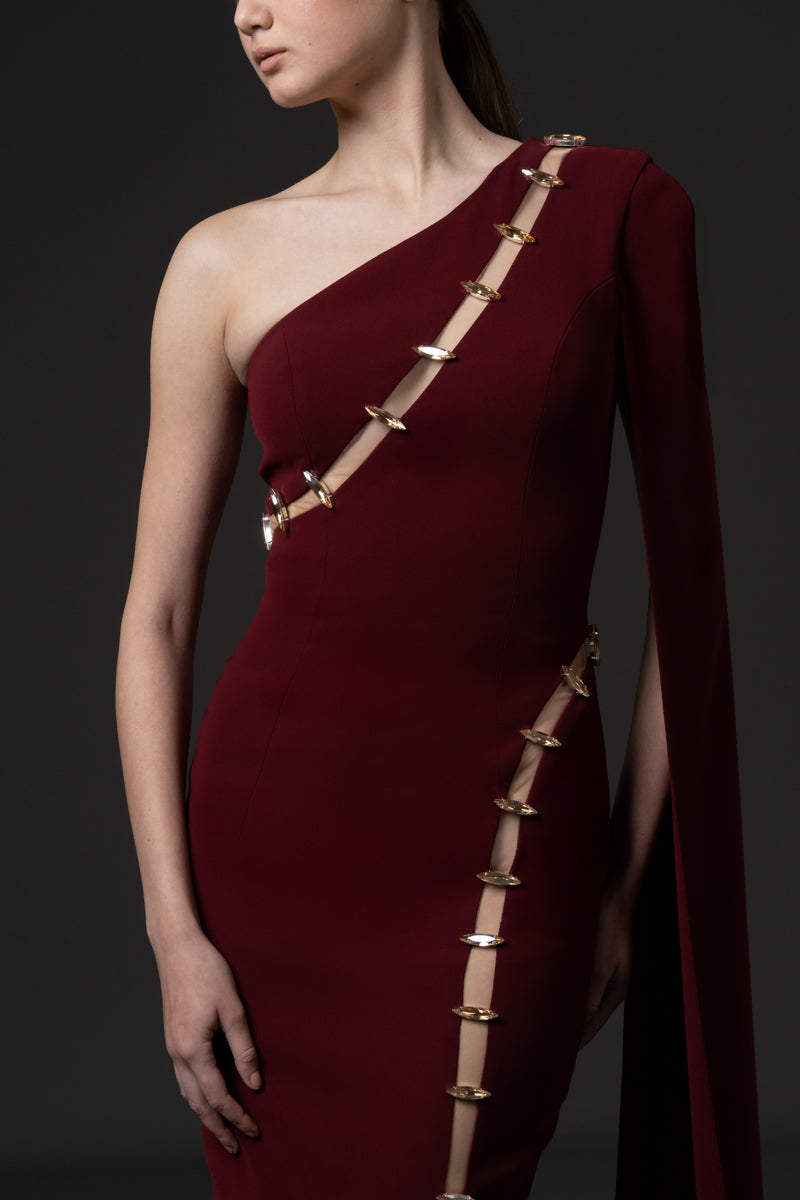 Asymmetrical fitted gown with cutouts and stones