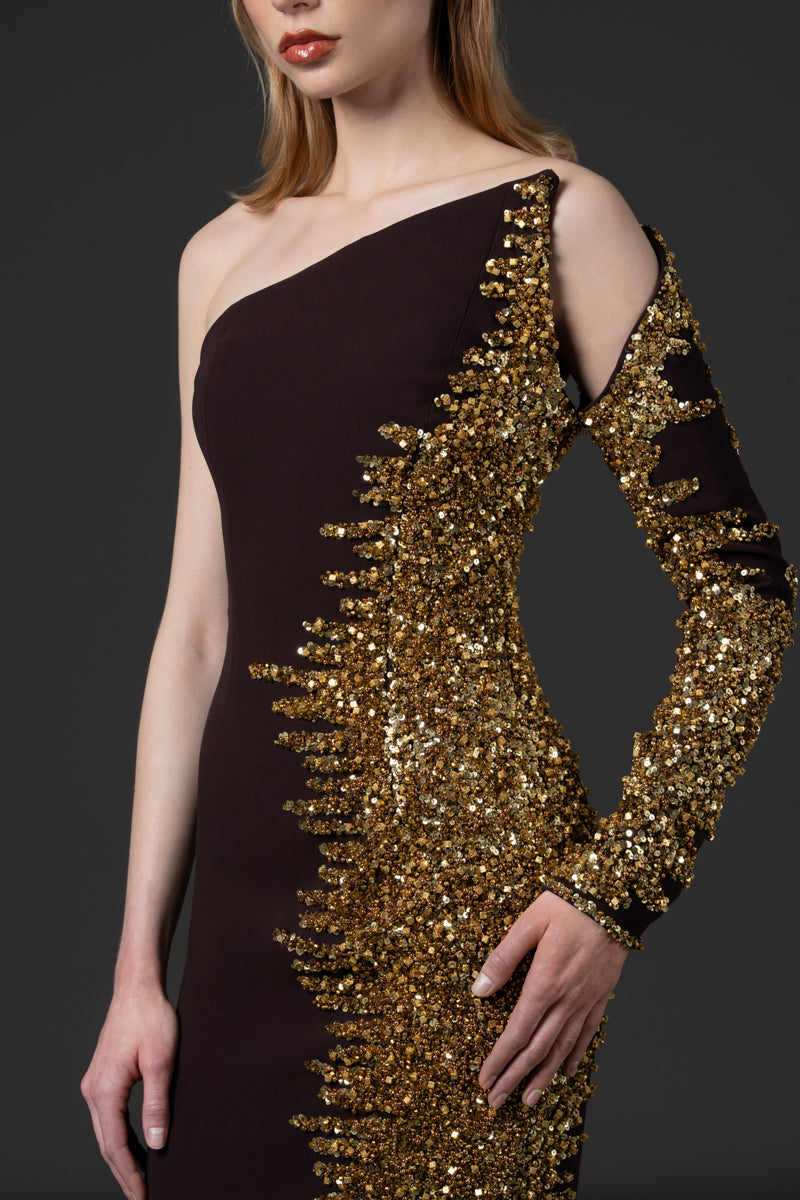 An asymmetrical fitted dress beaded with sequins along one side