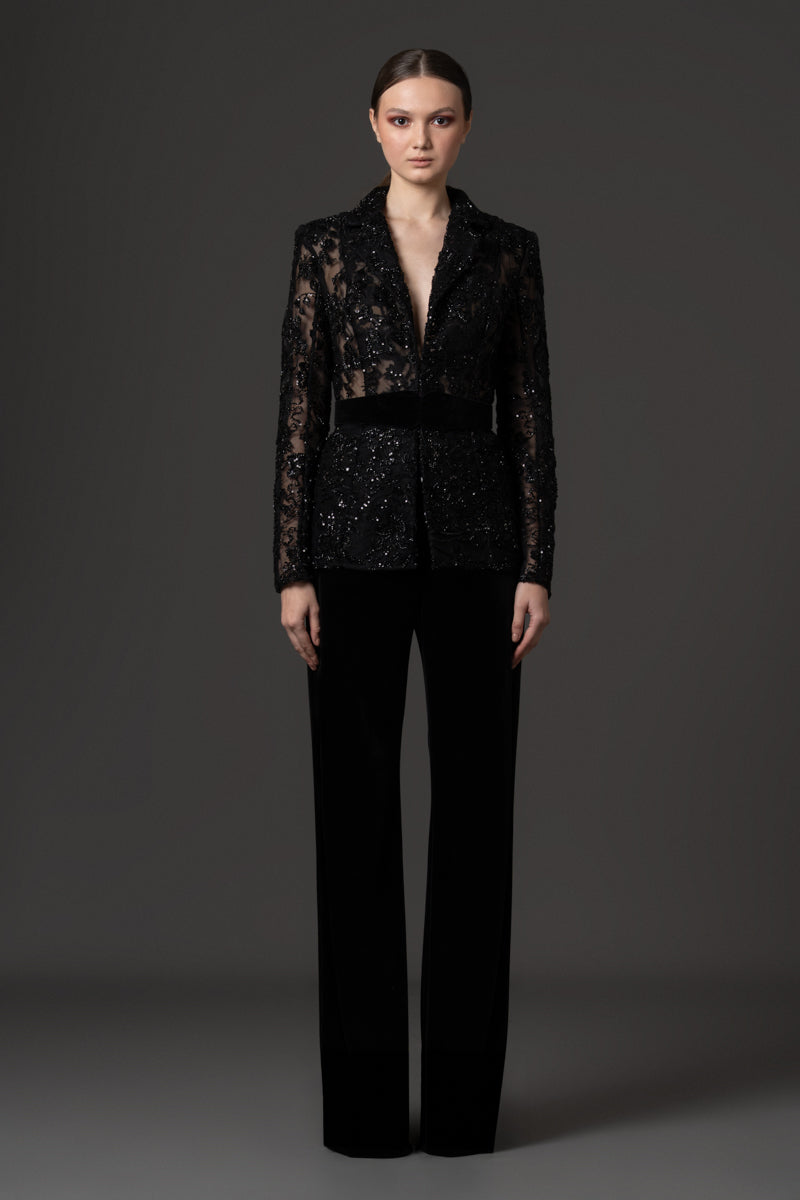 Embroidered blazer with a high-waisted belt, paired with velvet trousers