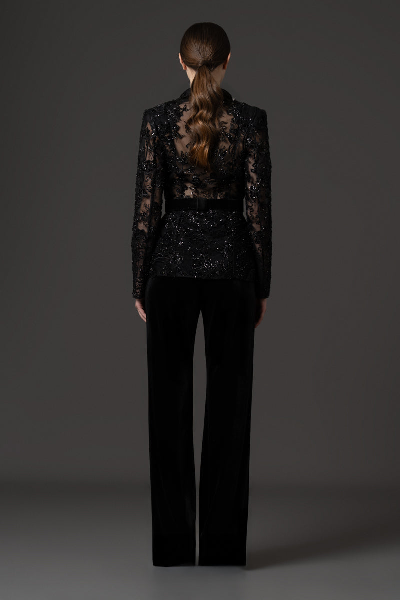 Embroidered blazer with a high-waisted belt, paired with velvet trousers