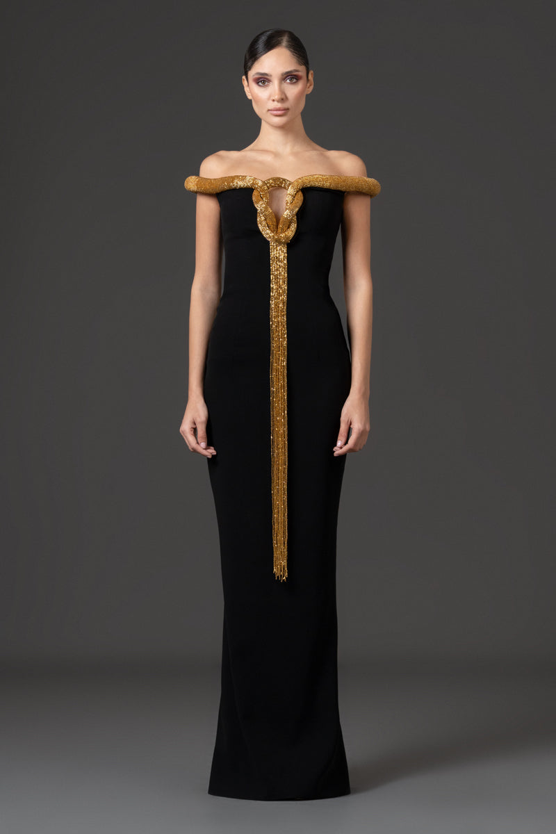 Off the shoulder crêpe gown featuring an embroidered neckline with fringes