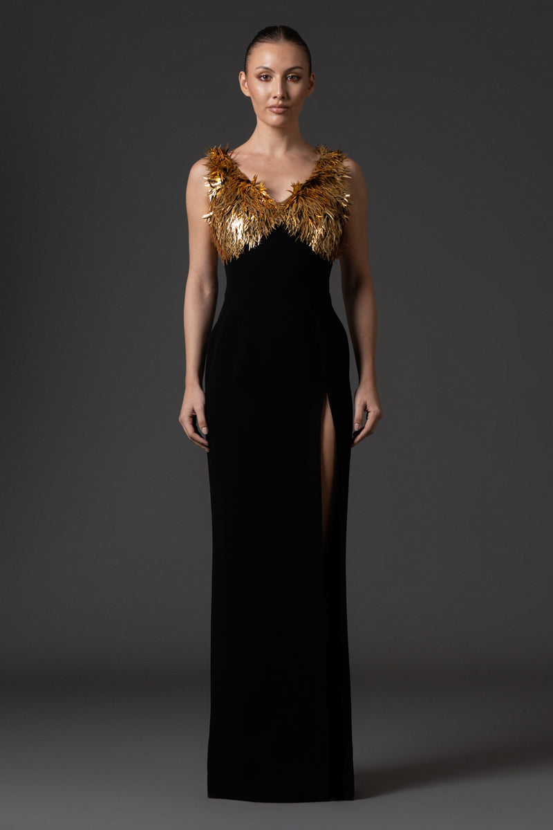 Black crêpe dress, featuring gold spike embroidery and a side slit.