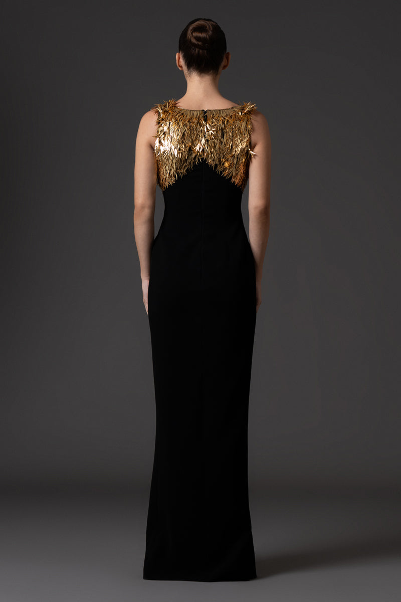 Black crêpe dress, featuring gold spike embroidery and a side slit.