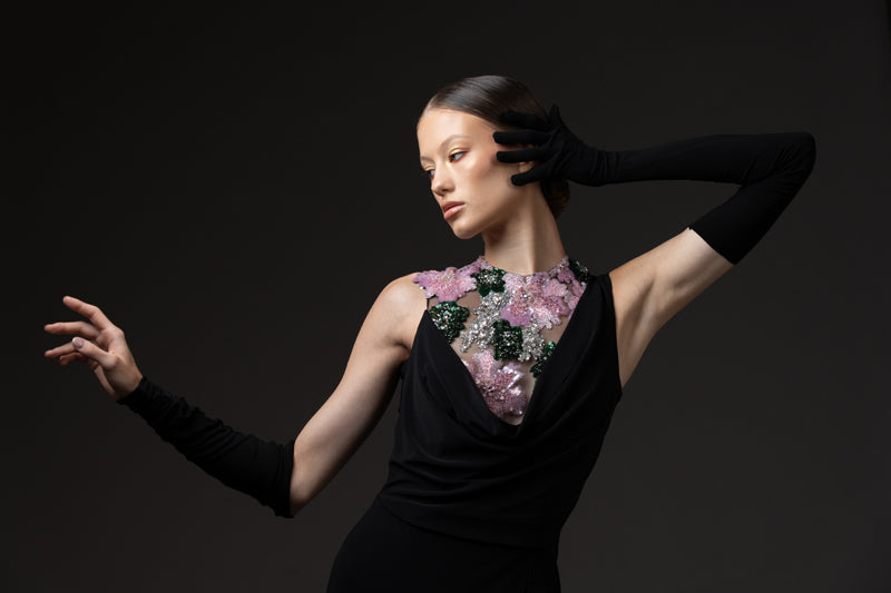 Black jersey dress with gloves, featuring floral embroidery on the bodice
