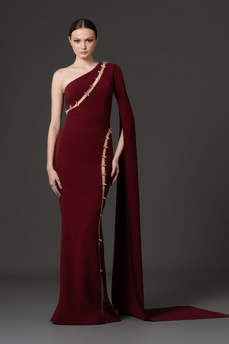 Asymmetrical fitted gown with cutouts and stones