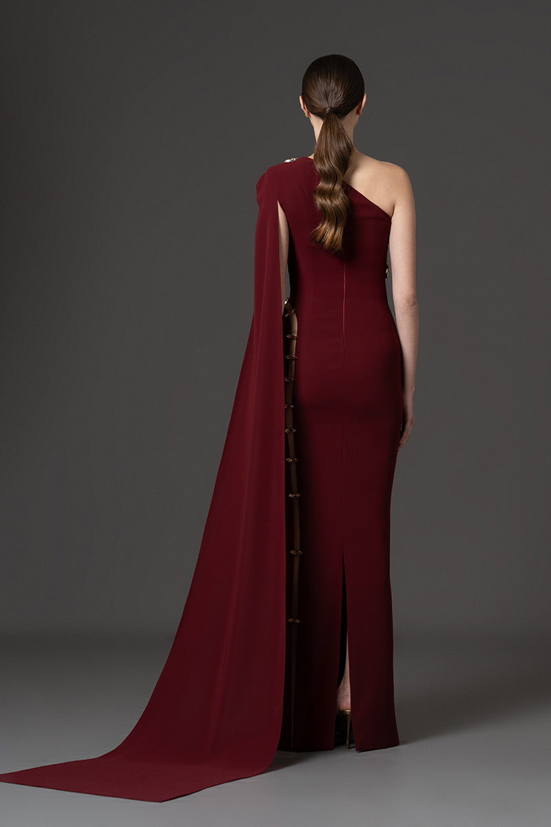 Asymmetrical fitted gown with cutouts and stones