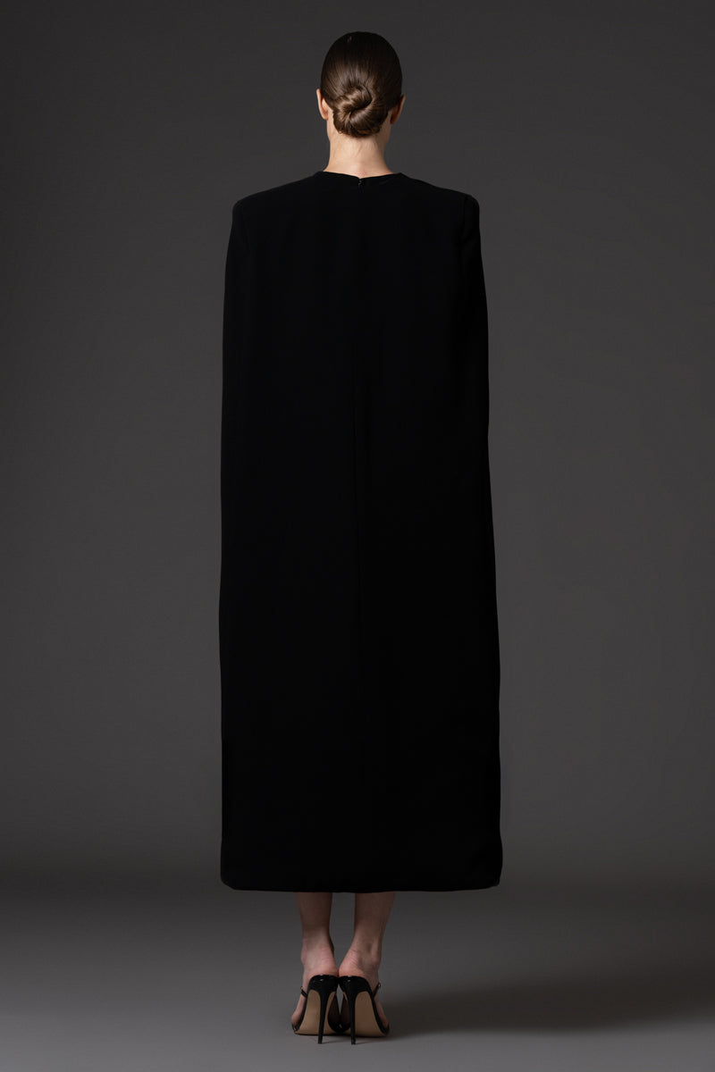 Embroidered short black crêpe dress paired with a cape